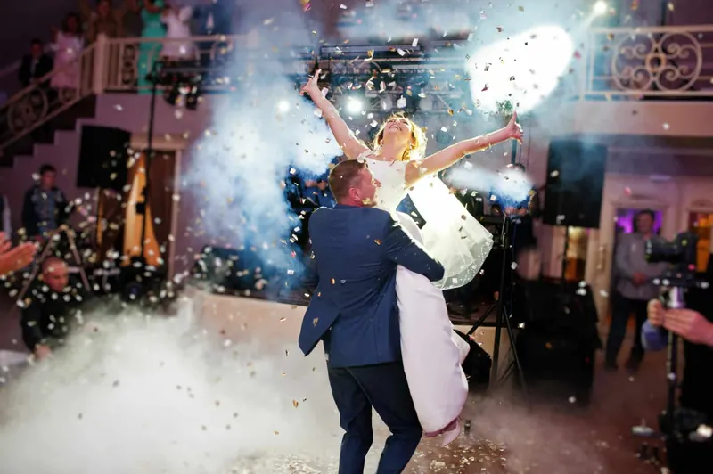 Couple surrounded by low fog and confetti on the dance floor