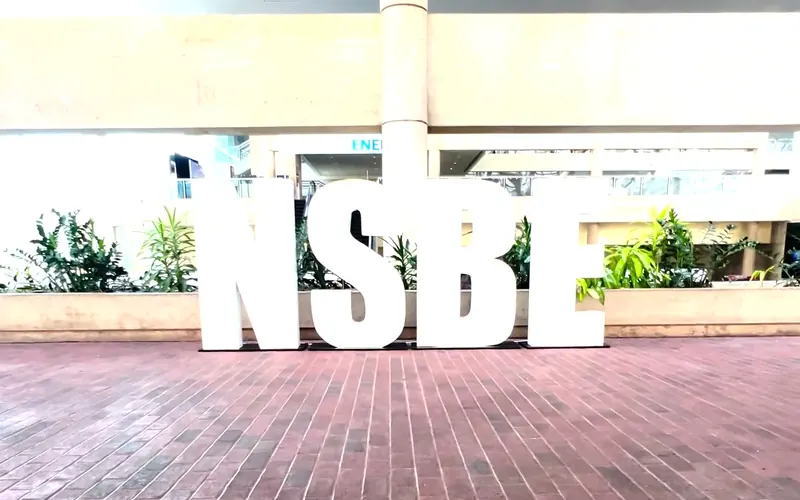 Giant white marquee letters spelling NSBE at an outdoor event